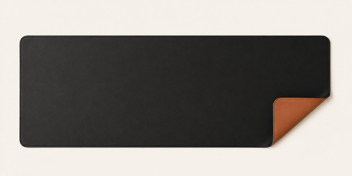 TheDorms 01 reversible desk mat in technical leather, black side, on a plain background.